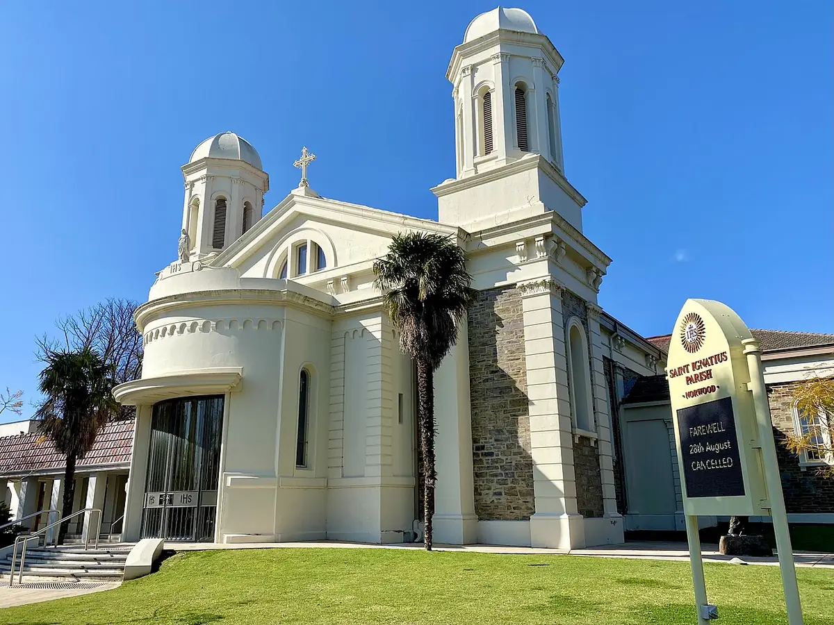 L'église Saint-Ignace et ses deux tours blanches, des palmiers et une pelouse à Norwood, Adélaïde