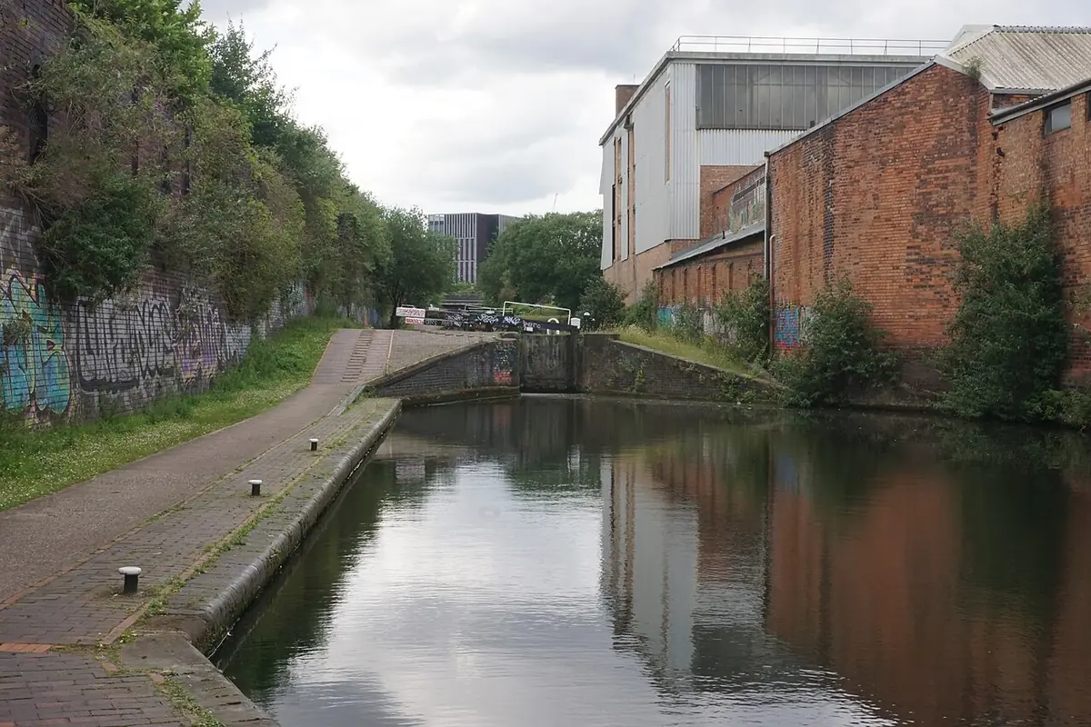 Aston Lock on the Birmingham & Fazeley Canal, towpath beside red-brick warehouses