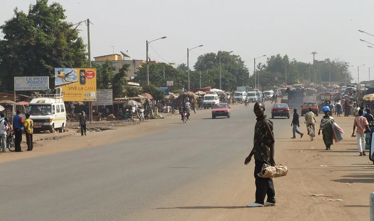 Une rue animée de Bouaké avec commerces et passants