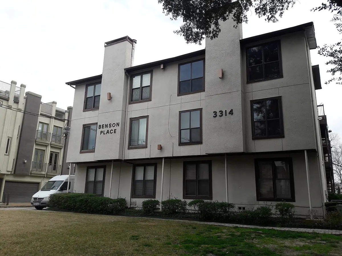 Benson Place, a modern three-story apartment building in Dallas with dark-framed windows