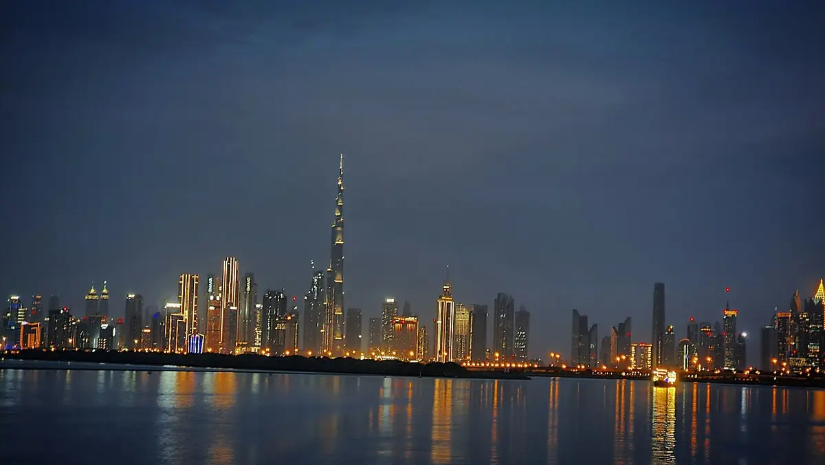 The Dubai skyline with Burj Khalifa reflected in the water at Dubai Creek Harbour
