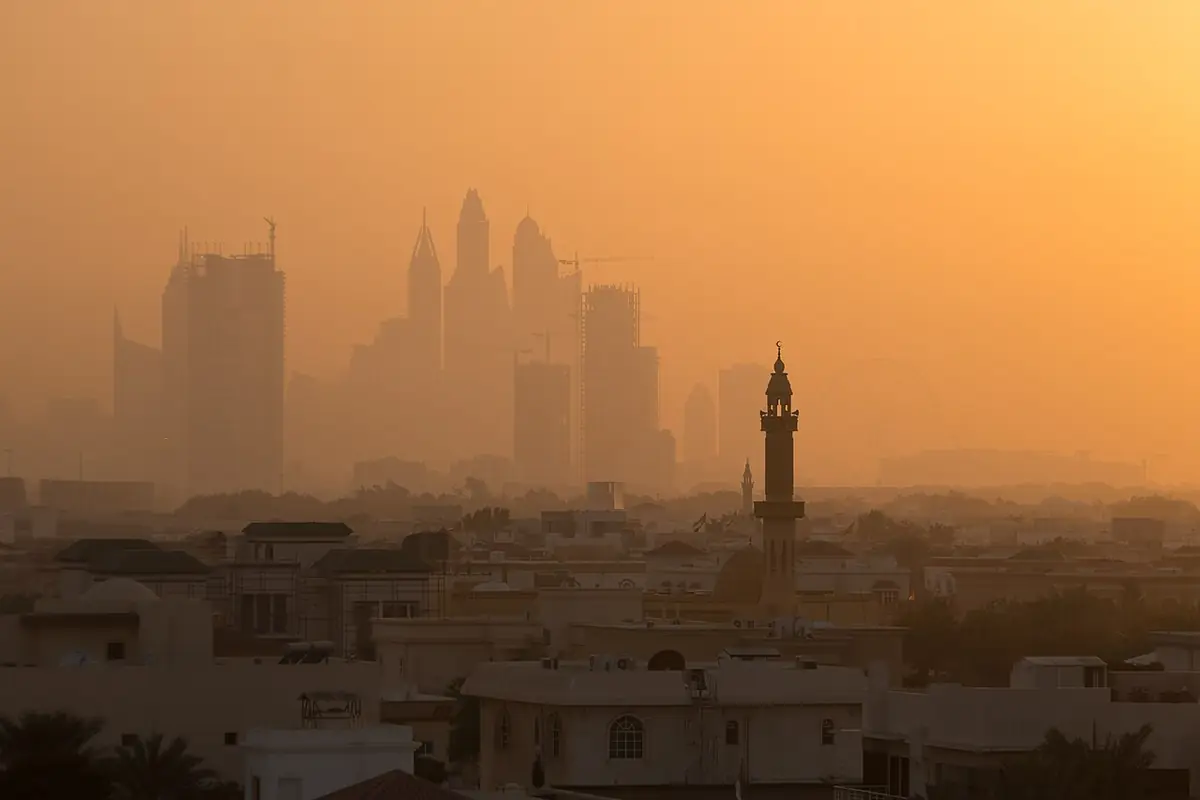 Dubai's skyline towers rising through a hazy dusk