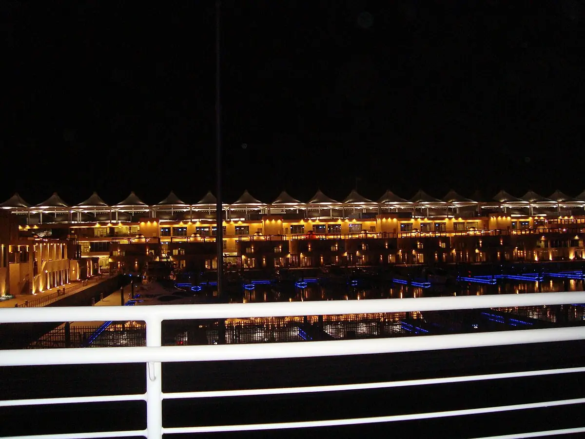 Yas Island's waterfront hotels lit up at night and reflected in the canal