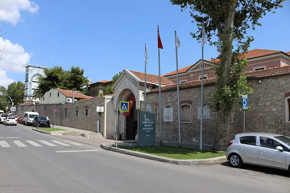 Un bâtiment historique en pierre avec drapeaux, dans une rue du quartier de Fatih à Istanbul