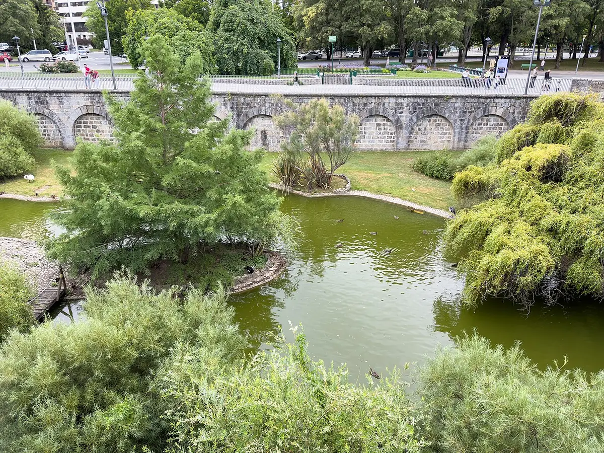 Étang et îlot boisé au pied des anciens murs dans le parc de la Taconera à Pampelune