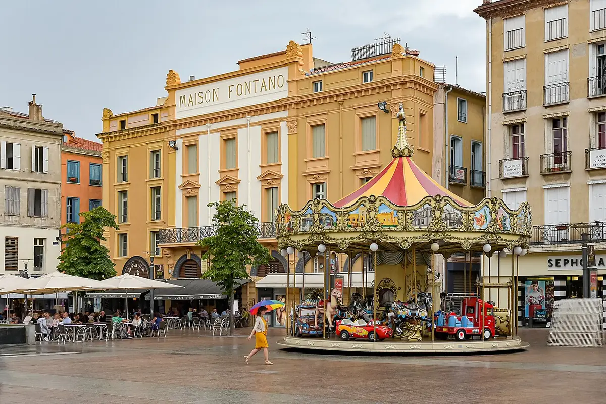 La place de la République à Perpignan, avec un manège devant la façade de la Maison Fontano