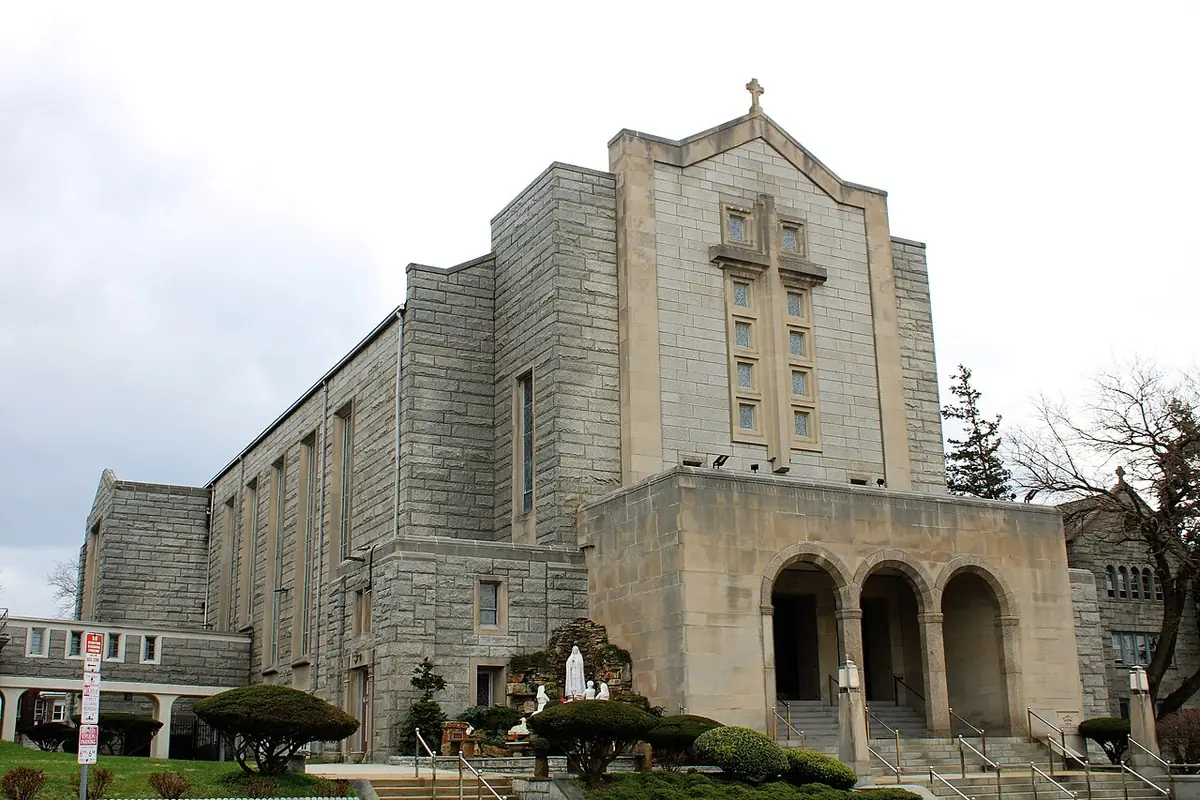 St. Helena Catholic Church, a stone building with a grotto and garden in front